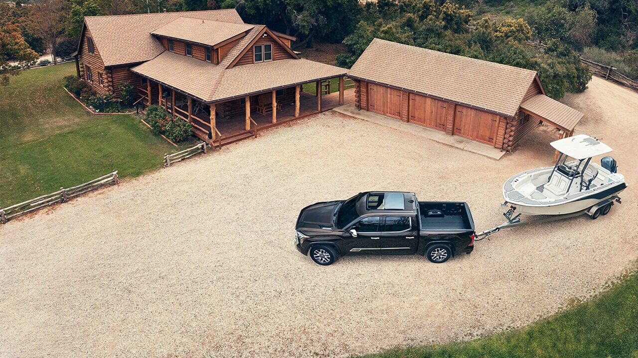 2022 Tundra towing a boat parked in driveway