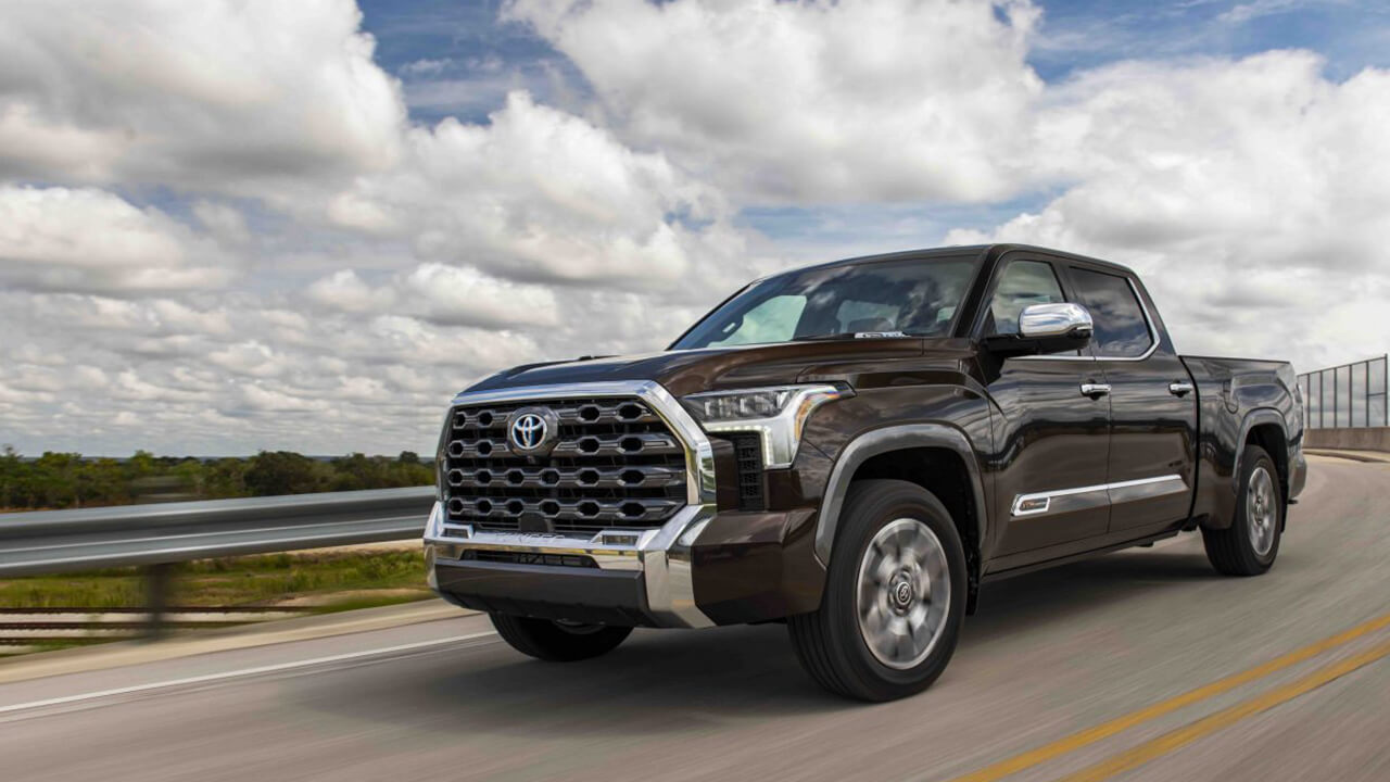 Brown 2024 Toyota Tundra driving in the countryside