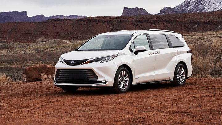 A white Sienna rests in a desert field. 