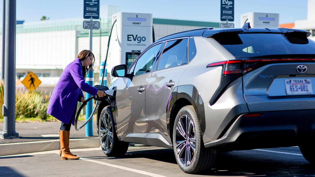 Woman charging her Toyota